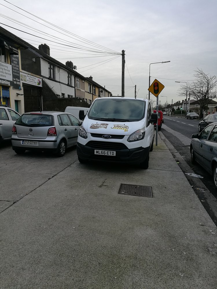 Cars parked on footpath